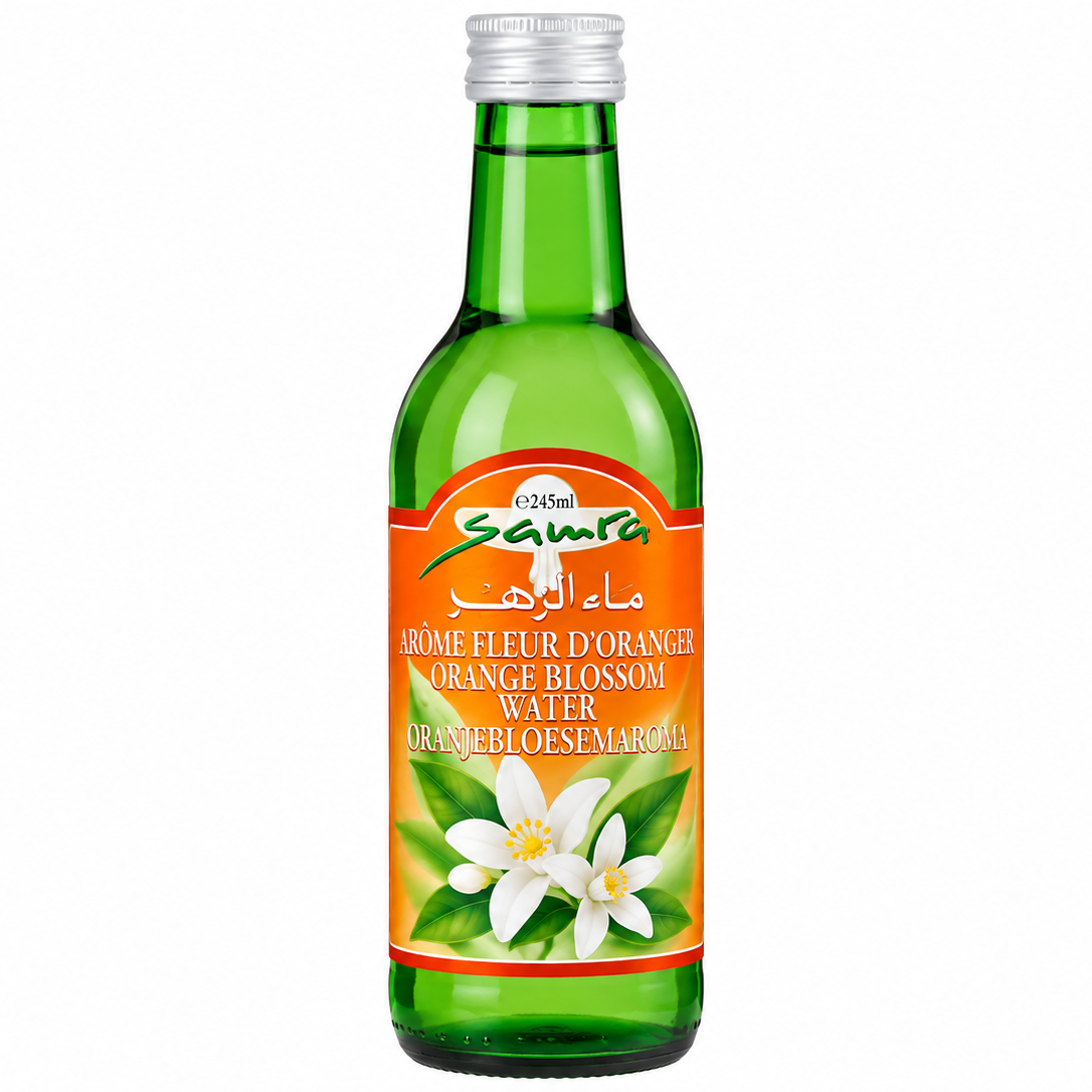 A green glass bottle of Sanfa Orange Blossom Water with a white cap and a bright orange label featuring white flowers, on a plain white background.